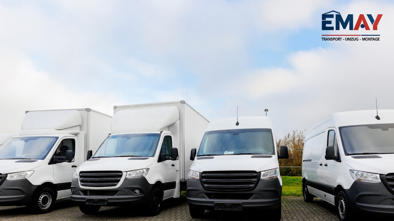 EMAY Transport Fuhrpark mit vier weißen Möbeltransportern und Kastenwagen in Dortmund